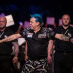 Peter Wright walking on at a Premier League Darts event.
