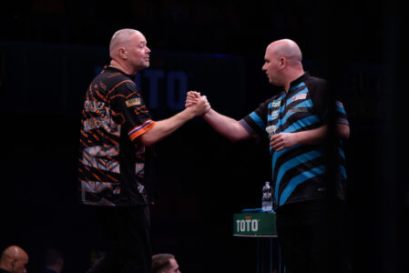 Raymond van Barneveld and Rob Cross touch knuckles at the Dutch Darts Masters