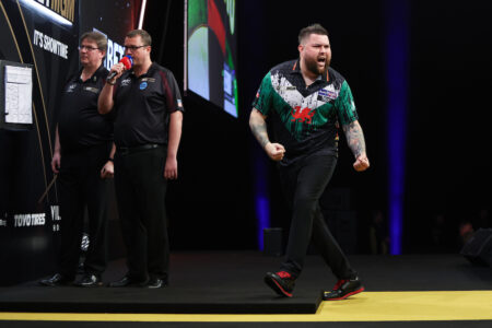 Michael Smith celebrating on the 2024 Premier League Darts stage.