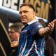 Gerwyn Price playing on stage at the 2024 Premier League Darts.