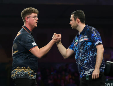 Luke Humphries and Ted Evetts shaking hands on stage at the 2026 Paddy Power World Darts Championship.