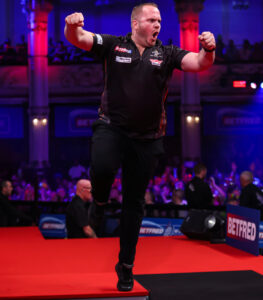 Dirk van Duijvenbode shouting in celebration on the Winter Gardens stage after winning his dramatic 13-11 overtime match against Chris Dobey at the 2026 World Matchplay.