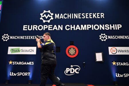 Luke Littler applauding on stage at the 2026 European Championship.