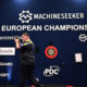 Luke Littler applauding on stage at the 2026 European Championship.