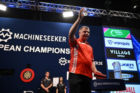 Krzysztof Ratajski on stage celebrating during the 2026 European Championship. 