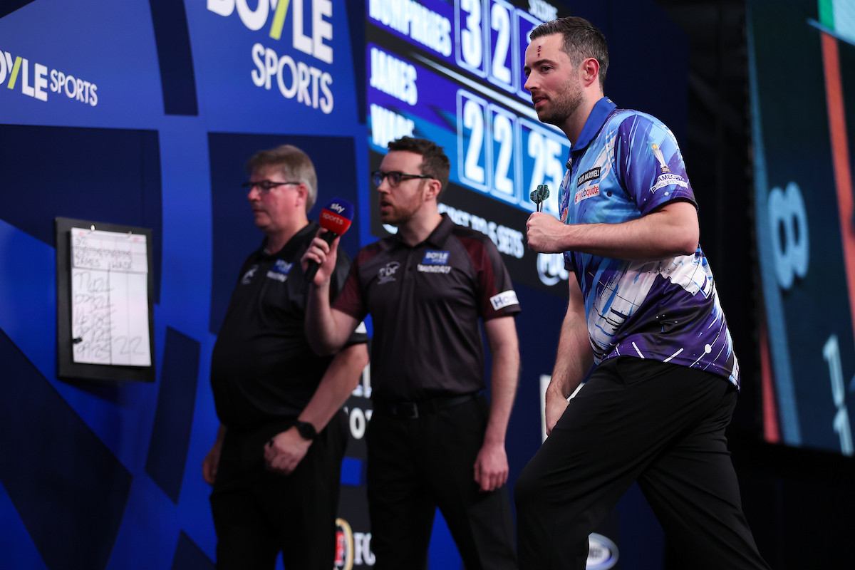 Luke Humphries celebrates on stage during the 2026 World Grand Prix.